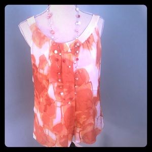 Sleeveless shell with a round neck in orange hues